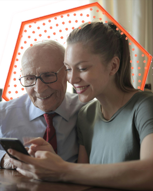 A young lady and an older gentleman looking at what seems like a smart phone.